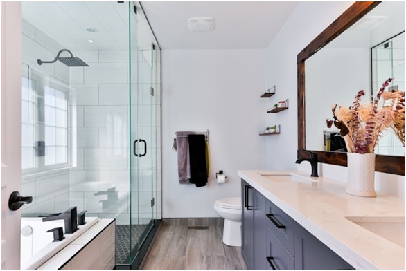 a modern bathroom with wood flooring and a glass shower